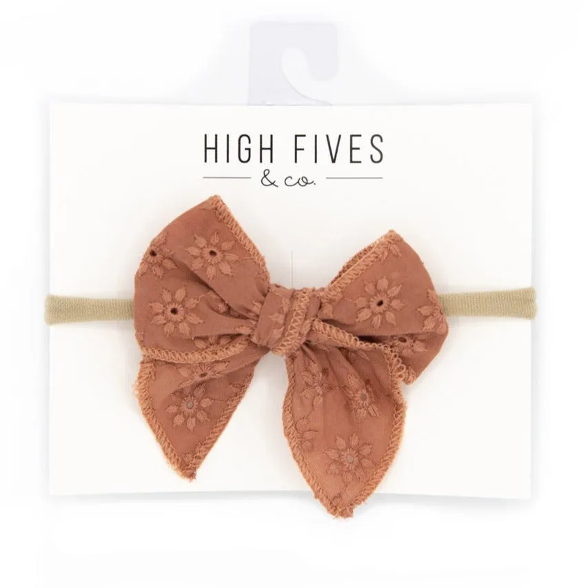 Eyelet Lace Bow with Pointed Tails on Nylon Headband